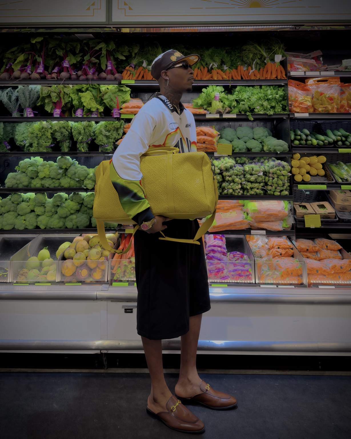 Claudio Conde carrying a Voltage Yellow duffle bag for his Rick Ross × Edition22 collaboration